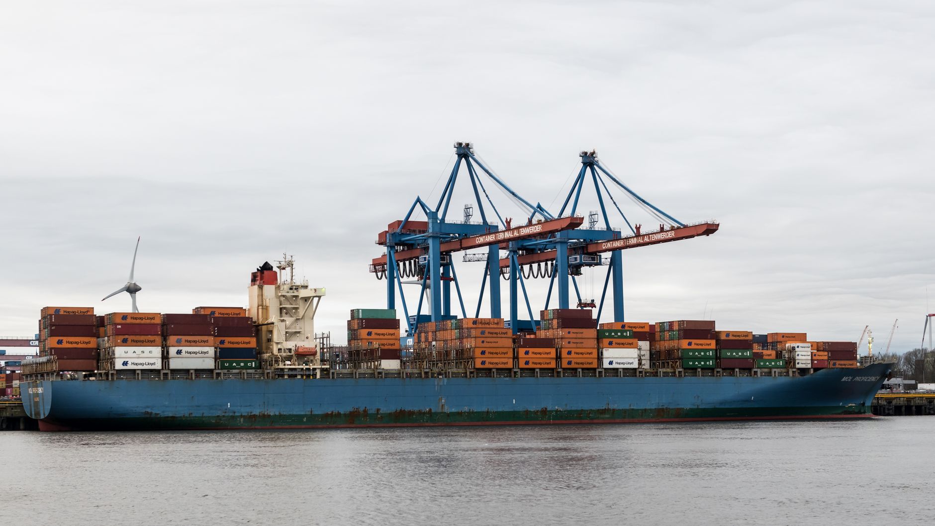 container ship at hamburg port with cranes